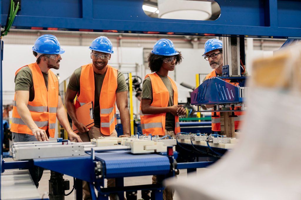 Engineers supervising automated packaging system in modern factory